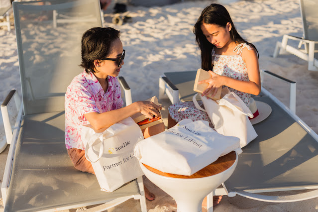 Sun Life Fulfills Client’s Dream Boracay Trip With Her Familya Group of People Walking on a Beach