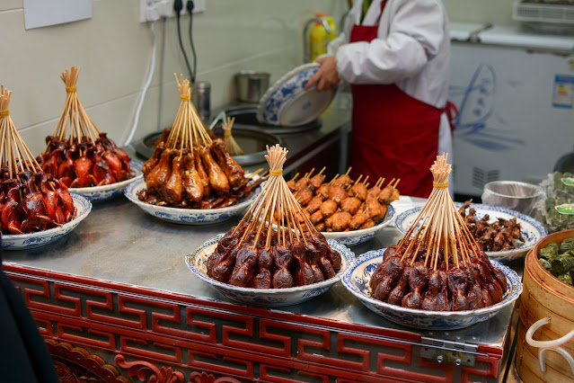 traditional chinese food on display with a man coo 2024 01 30 00 33 34 utc min