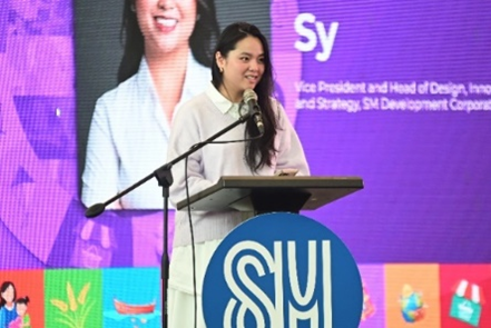 A person standing at a podium with microphone

AI-generated content may be incorrect.