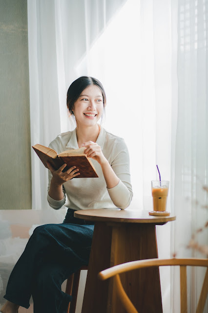 asian female college student reading a book in a c 2025 03 09 20 15 15 utc